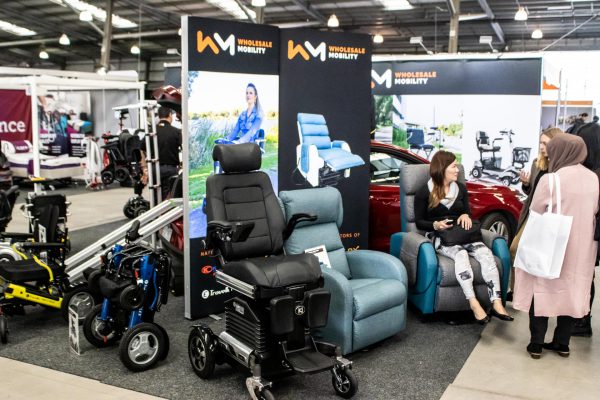 Visitors testing out a gallery of seating and mobility products at the Wholesale Mobility expo stand