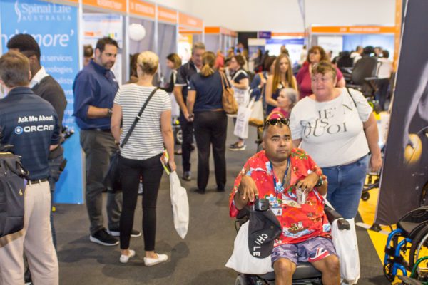A busy exhibition floor with people looking at expo stands - Brisbane Expo in 2019