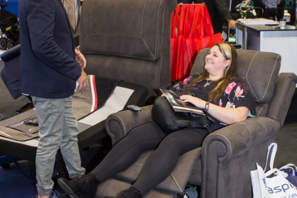 A woman trying out a recliner on display at the Brisbane ATSA Expo