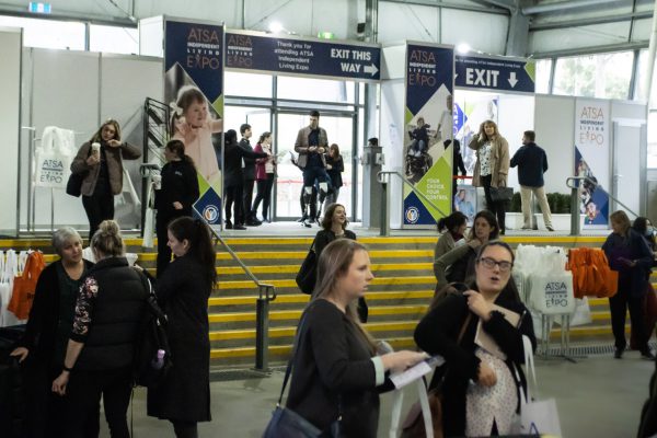 Image gallery of inside foyer entrance with people arriving on the expo floor