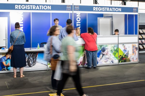 Registration desk with staff assisting visitors upon arrival to ATSA Canberra