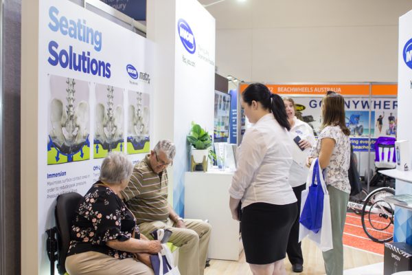 Invacare staff demonstrate their seating solutions to Brisbane Expo 2019 visitors