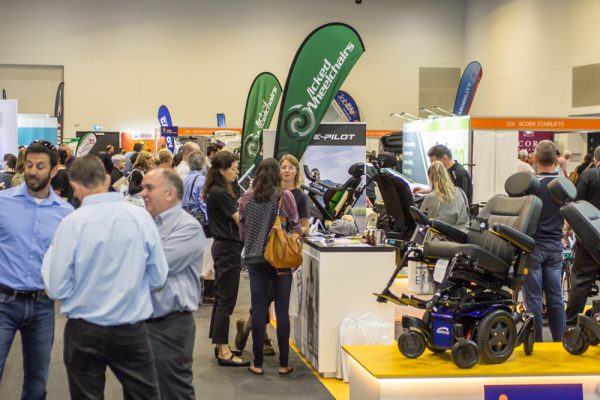 A photo of visitors looking at Wicked Wheelchair products on the Brisbane Expo floor in 2019