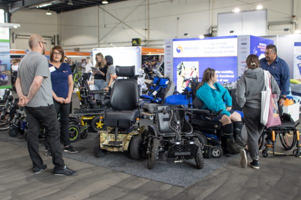 An image of visitors at the Specialised Wheelchair Company expo stand in Canberra