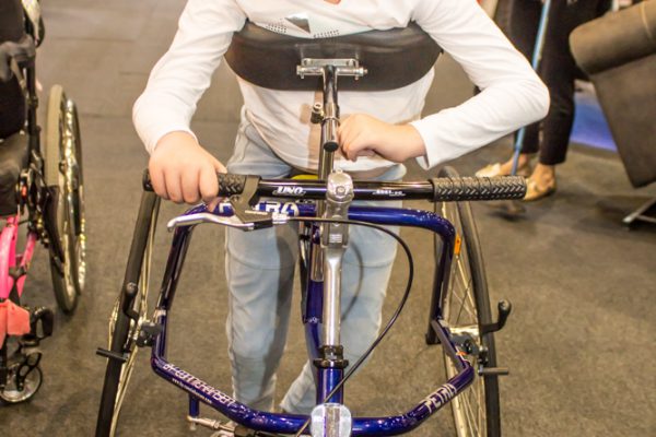 A young girl testing an accessible walker at Brisbane Expo