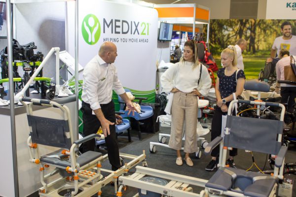 A photo of ATSA Brisbane Expo visitors from the 2019 event talking with MEDIX21 stand staff