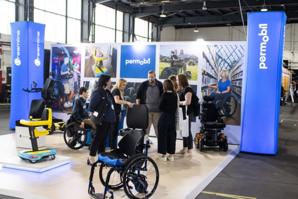 Permobil exhibitor staff talking to visitors at the ATSA Independent Living Expo in Canberra