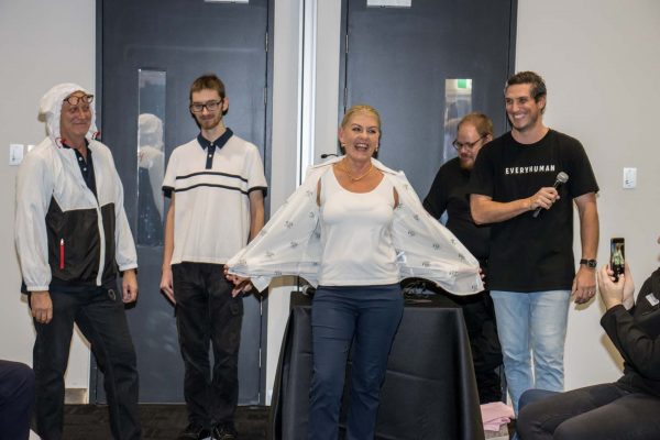 A woman showcasing an adaptive clothing t-shirt at fashion show gallery - ATSA Brisbane 2022
