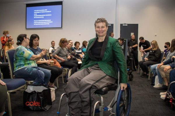 A wheelchair user showcasing an adaptive clothing item at fashion show gallery - ATSA Brisbane 2022