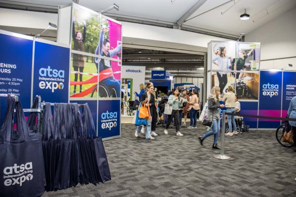 Visitors walking through the Welcome banner at the ATSA Independent Living Expo Sydney 2022 entrance