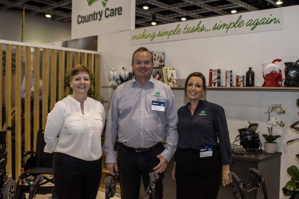Three exhibitors from Country Care posing for the camera, smiling