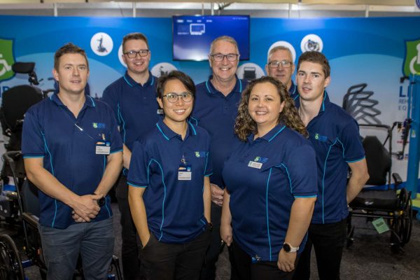 A team of exhibitors posing for the camera at their expo stand - ATSA Brisbane 2022 image gallery